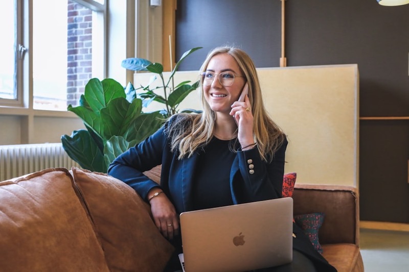 A client uploading documents from her phone and laptop